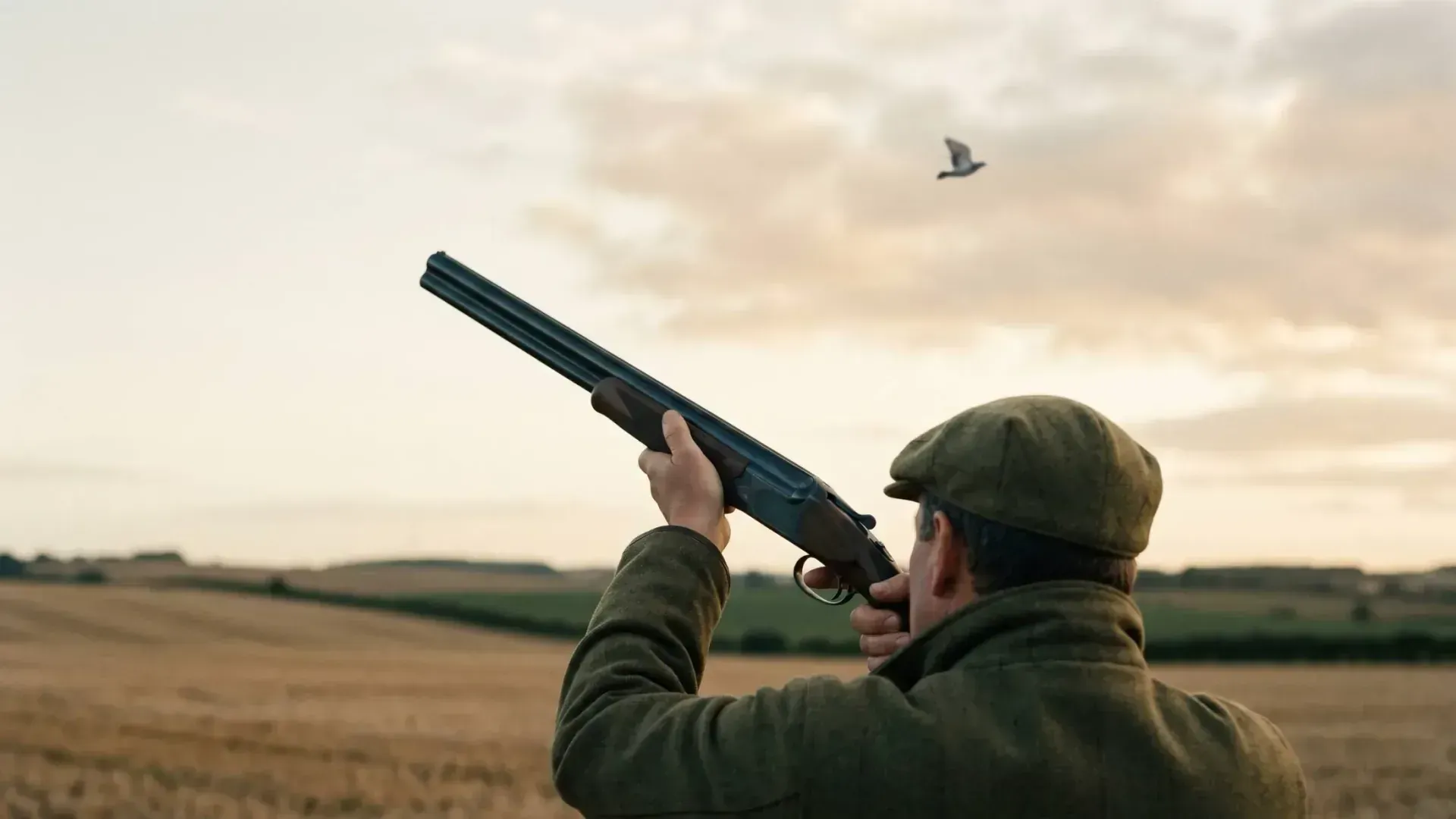 Gun mounting an over-and-under shotgun against a dawn Free State sky